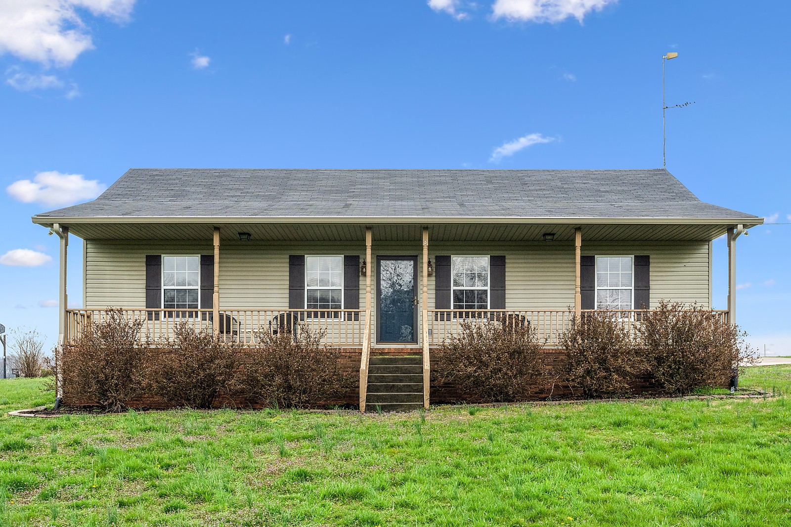 4415 Matthews Road Cedar Hill, TN 37032 - Photo 1 of 19 a front view of a house with a garden