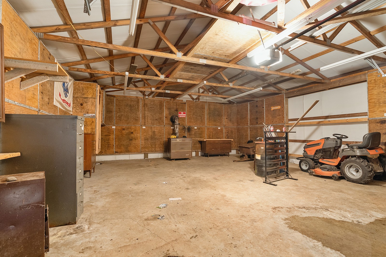 4415 Matthews Road Cedar Hill, TN 37032 - Photo 19 of 19 a view of a garage with a bike and wooden roof