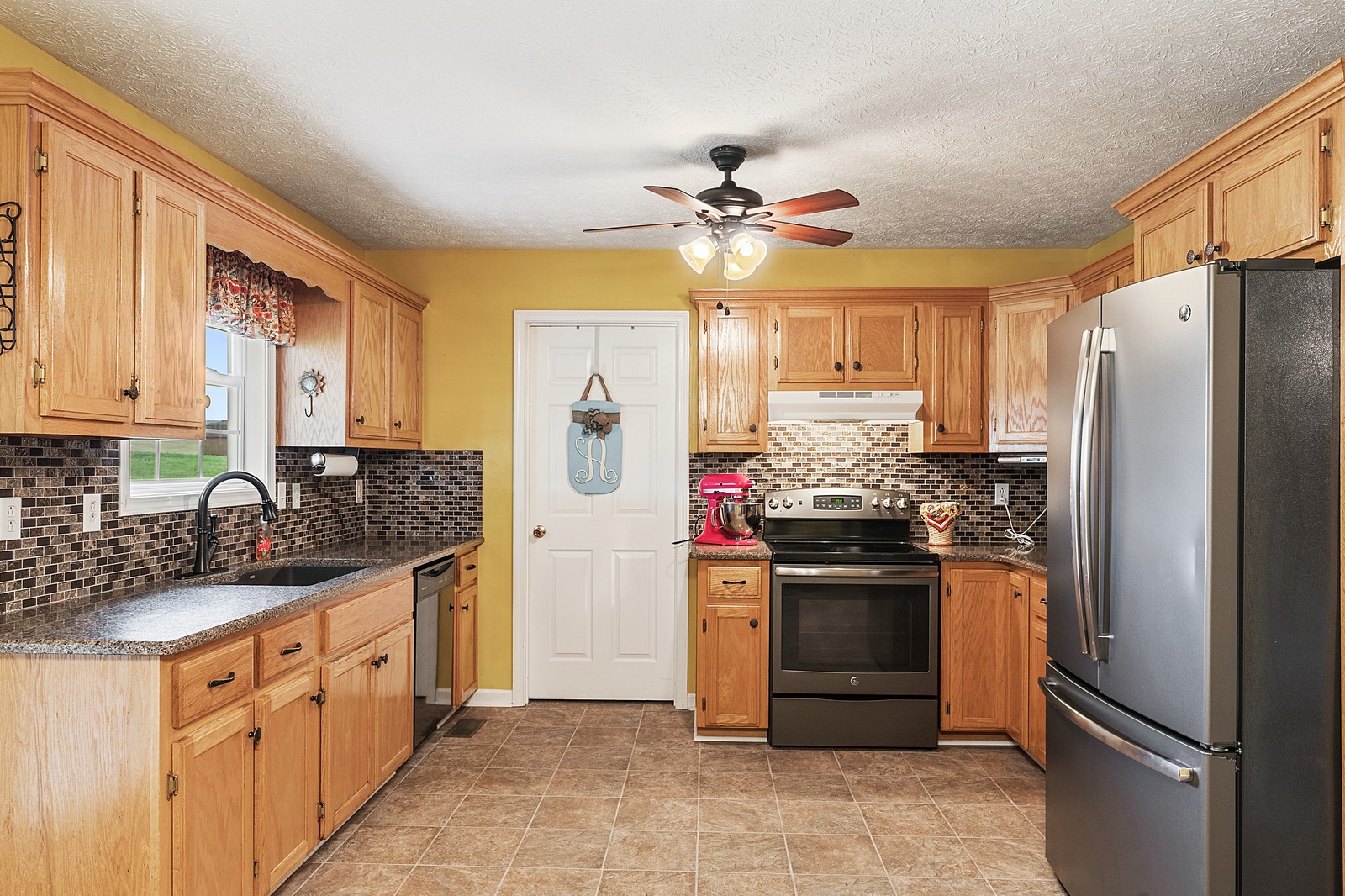 4415 Matthews Road Cedar Hill, TN 37032 - Photo 8 of 19 a kitchen with stainless steel appliances granite countertop a refrigerator a stove a sink and dishwasher