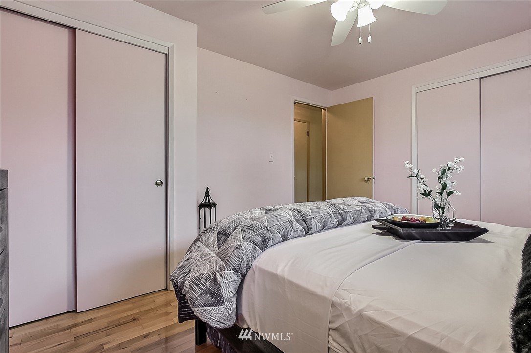 3701 Northeast 9th Street Renton, WA 98056 - Photo 11 of 13 a bedroom with a bed and a chandelier