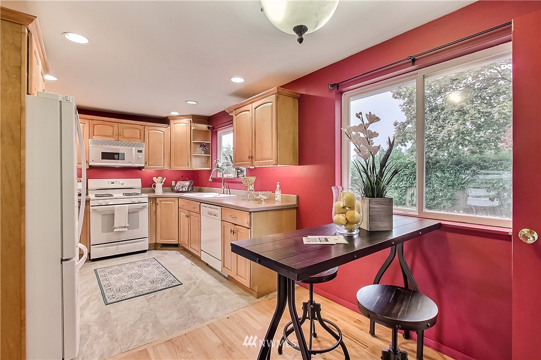 3701 Northeast 9th Street Renton, WA 98056 - Photo 5 of 13 a kitchen with a dining table chairs and white appliances