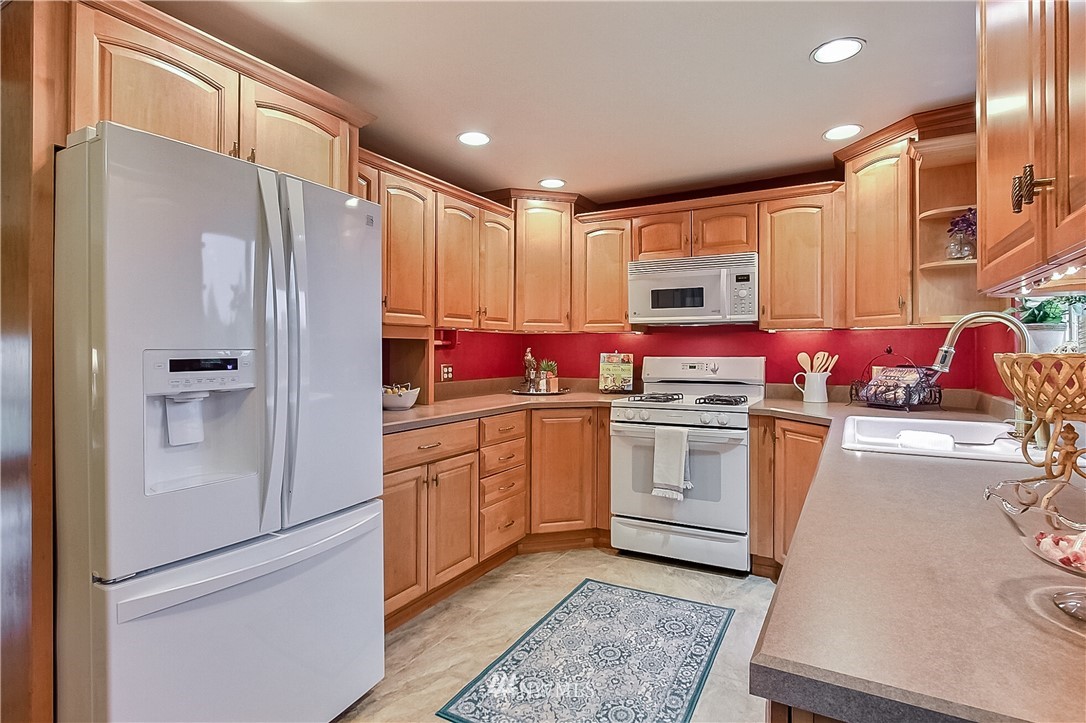 3701 Northeast 9th Street Renton, WA 98056 - Photo 6 of 13 a kitchen with stainless steel appliances a stove a sink and a refrigerator