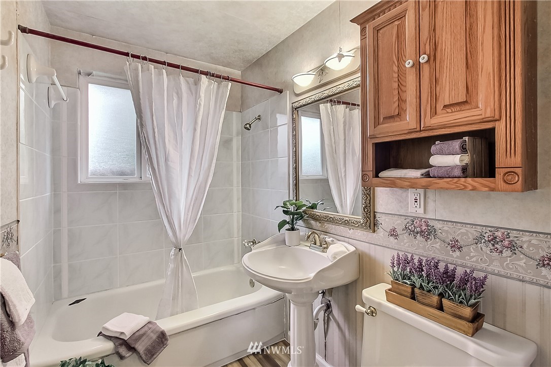3701 Northeast 9th Street Renton, WA 98056 - Photo 9 of 13 a bathroom with a sink a toilet and a bathtub