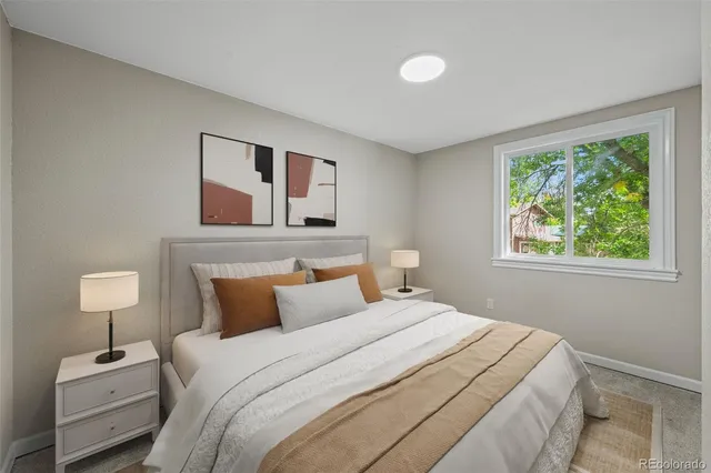 a bedroom with a bed and a lamp