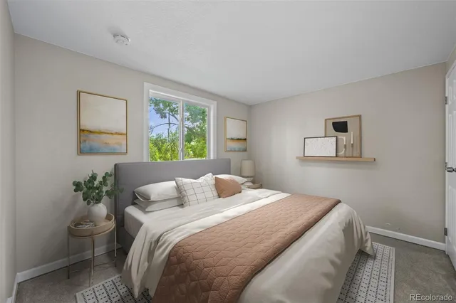 a bedroom with a bed and a painting on the wall