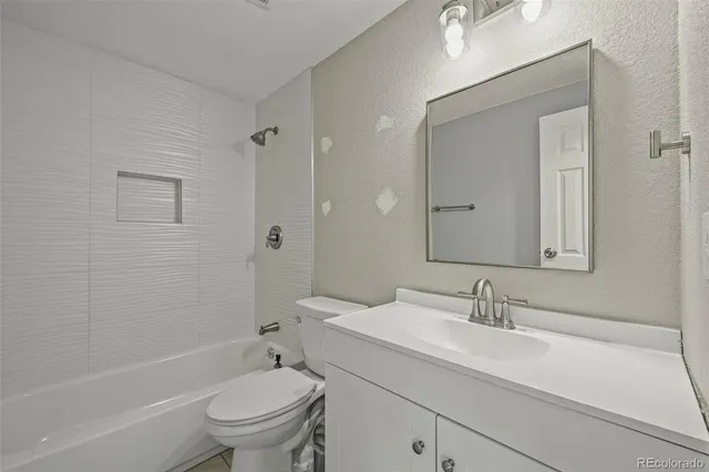 a bathroom with a sink toilet a tub and shower