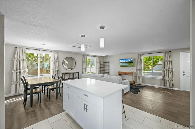 a large white kitchen with a large window
