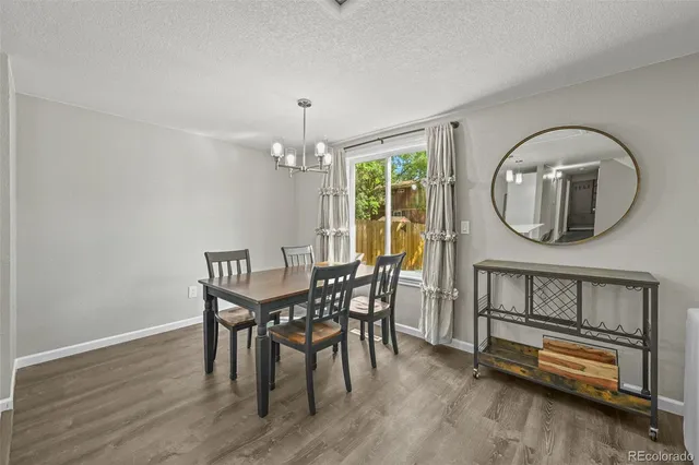 a view of a dining room with furniture and a chandelier