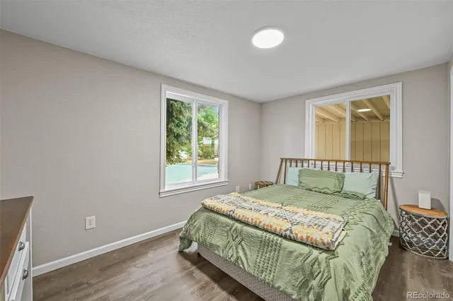 a bed sitting in a bedroom next to a window