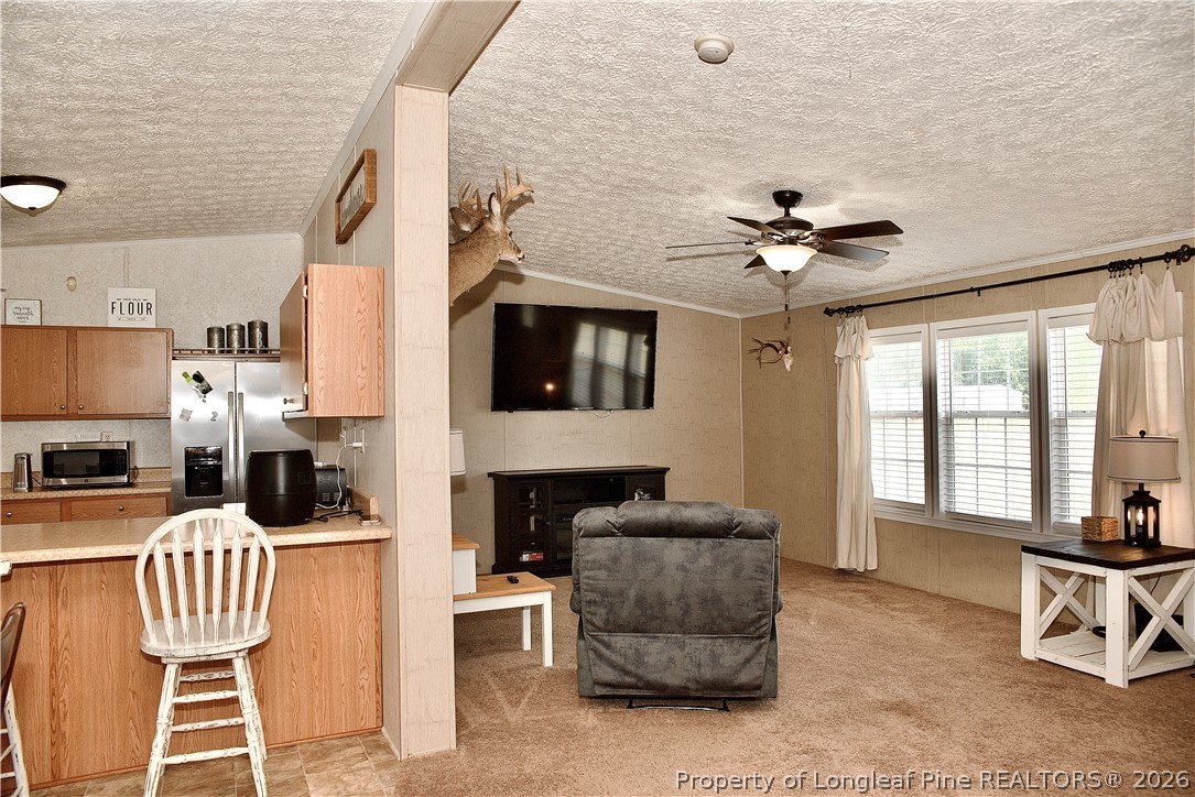 1071 Watts Road Lumberton, NC 28360 - Photo 5 of 31 a living room with furniture and a flat screen tv