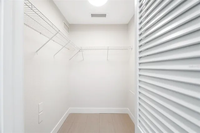 a bathroom with a shower and a ceiling fan