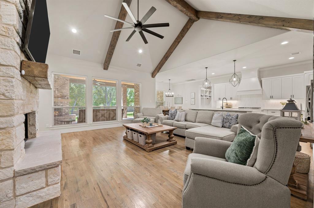 200 Clayton Crossing Springtown, TX 76082 - Photo 8 of 40 a living room with furniture wooden floor and a fireplace