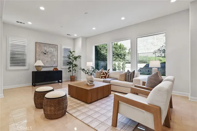 a kitchen with stainless steel appliances a sink a stove a refrigerator and cabinets