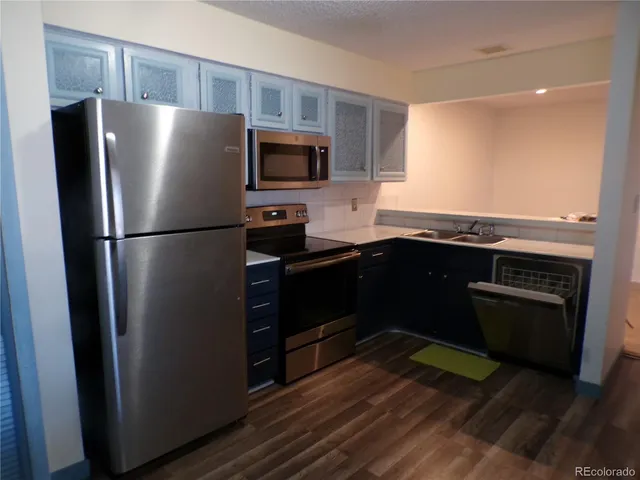 a view of a refrigerator in kitchen and wooden floor