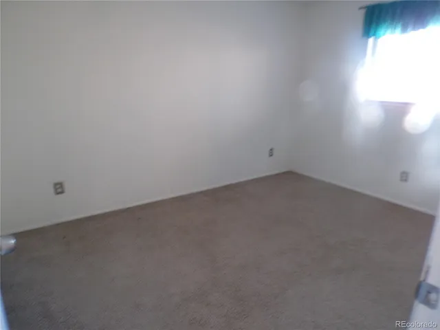 an empty room with closet area