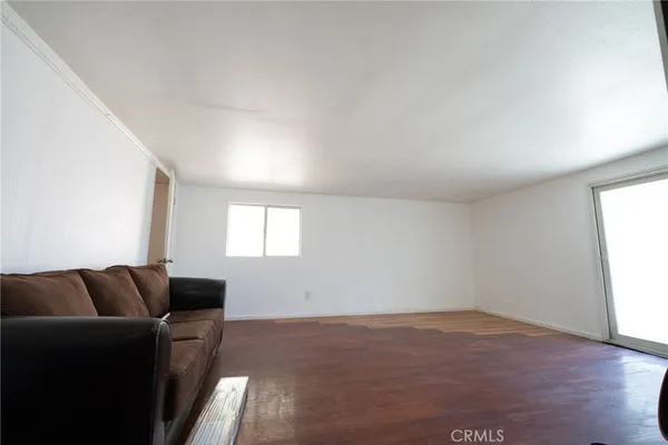 a living room with furniture and a air conditioner vent