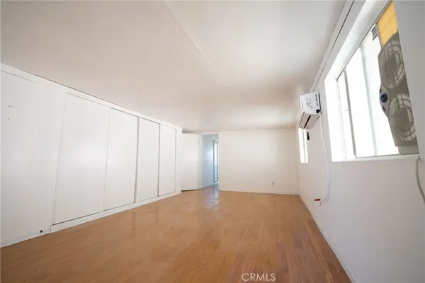 a view of an empty room and a window