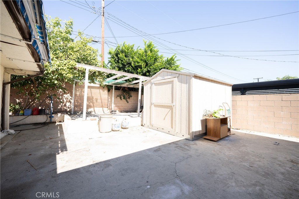 822 East Virginia Street Rialto, CA 92376 - Photo 17 of 20 a view of a patio with couches and table and chairs under an umbrella