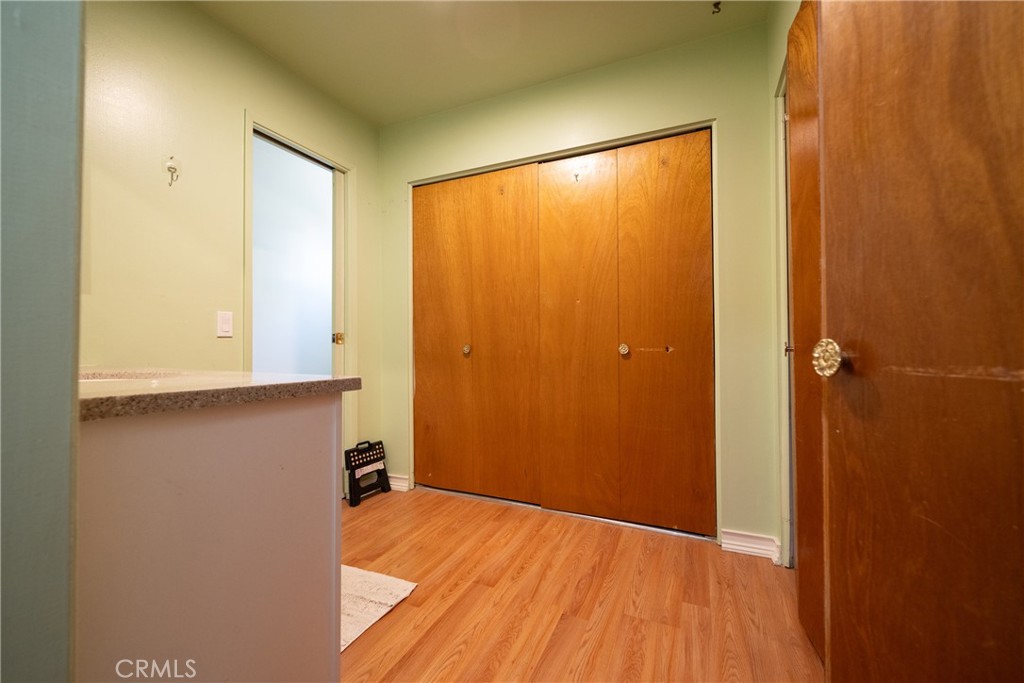 822 East Virginia Street Rialto, CA 92376 - Photo 9 of 20 a view of an empty room with wooden floor and a window