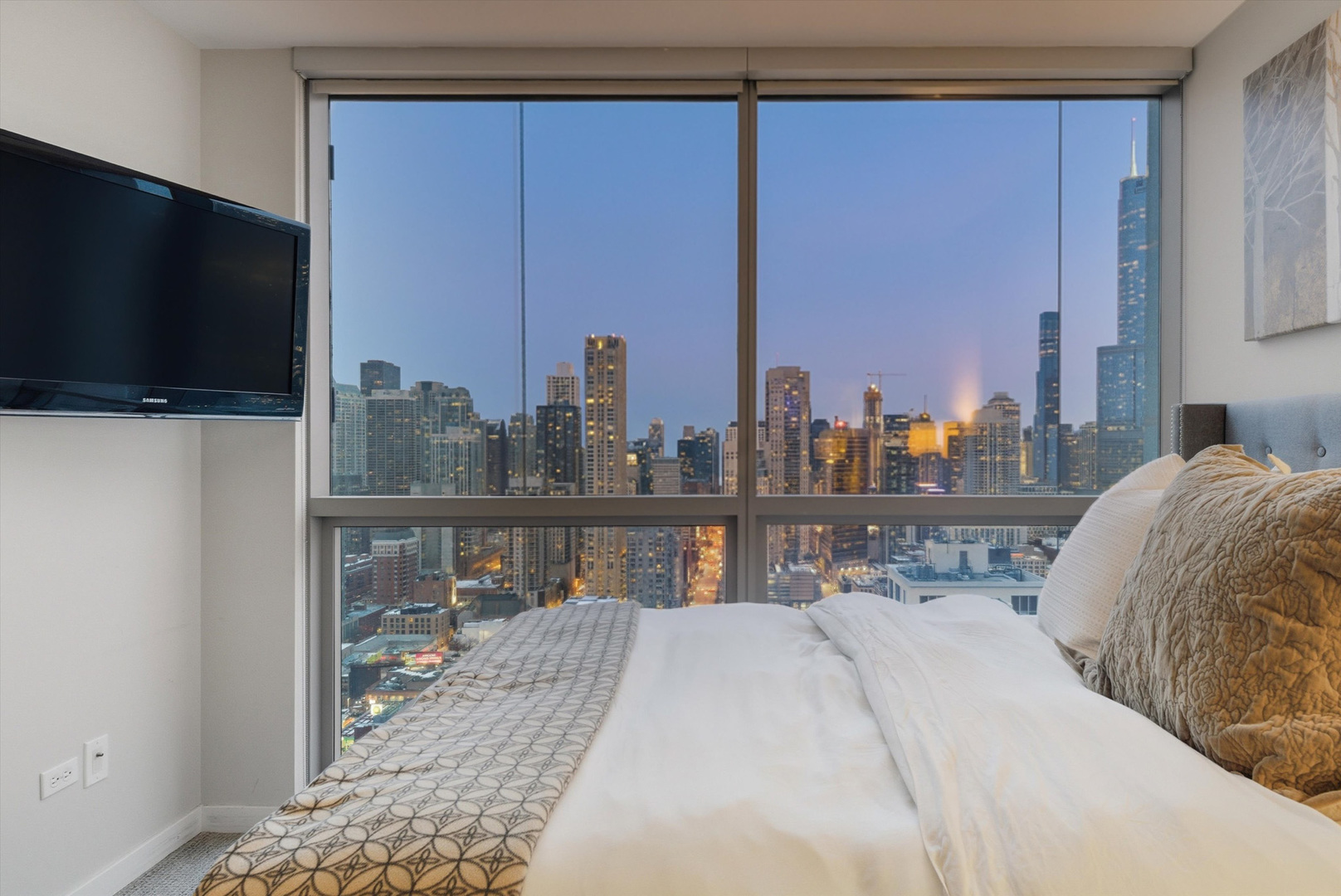 303 West Ohio Street, Unit 3502 Chicago, IL 60654 - Photo 24 of 41 a bedroom with a bed a flat screen tv and balcony view