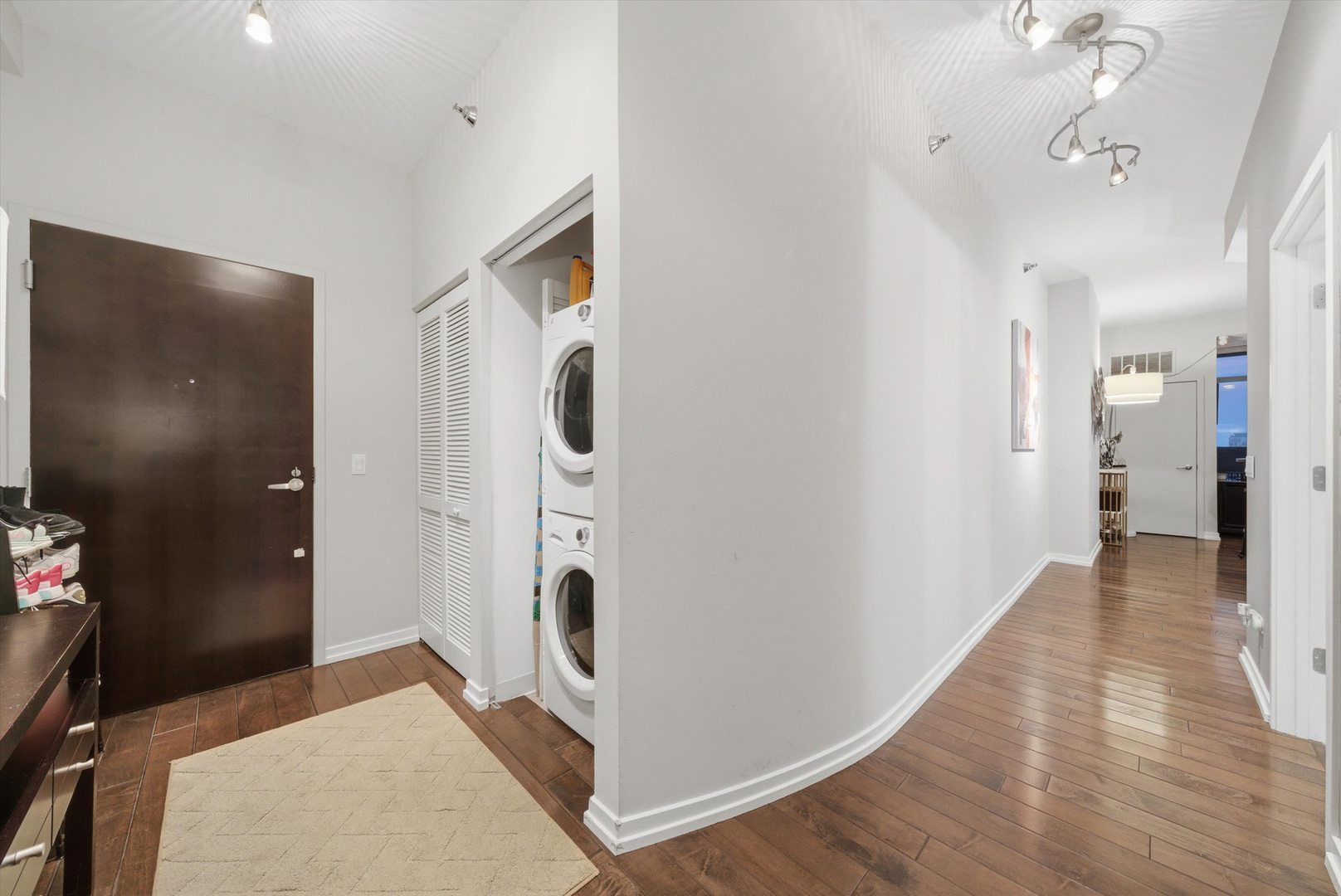 303 West Ohio Street, Unit 3502 Chicago, IL 60654 - Photo 27 of 41 a view of a hallway with wooden floor and a living room