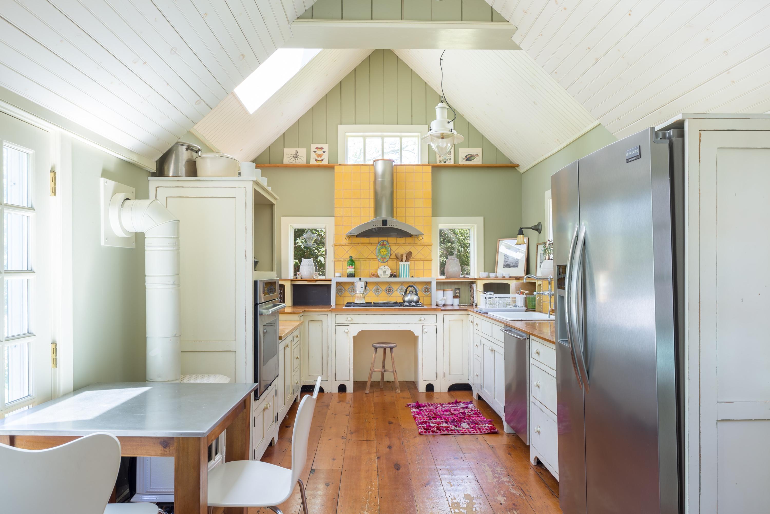 5 Depot Road Truro, MA 02666 - Photo 15 of 21 a kitchen with stainless steel appliances granite countertop a refrigerator a stove a sink dishwasher and white cabinets with wooden floor