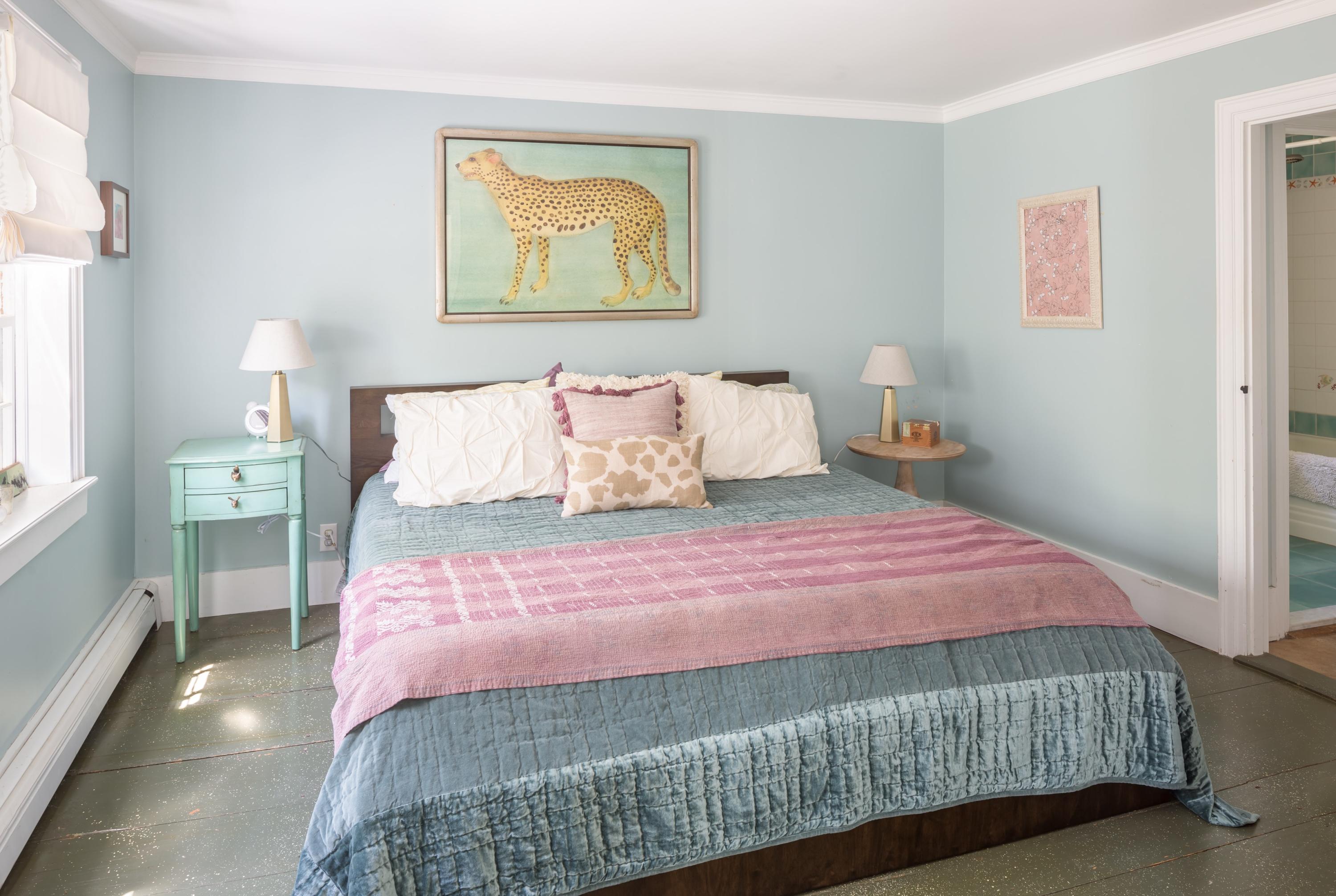 5 Depot Road Truro, MA 02666 - Photo 16 of 21 a bedroom with a bed and painting on the wall