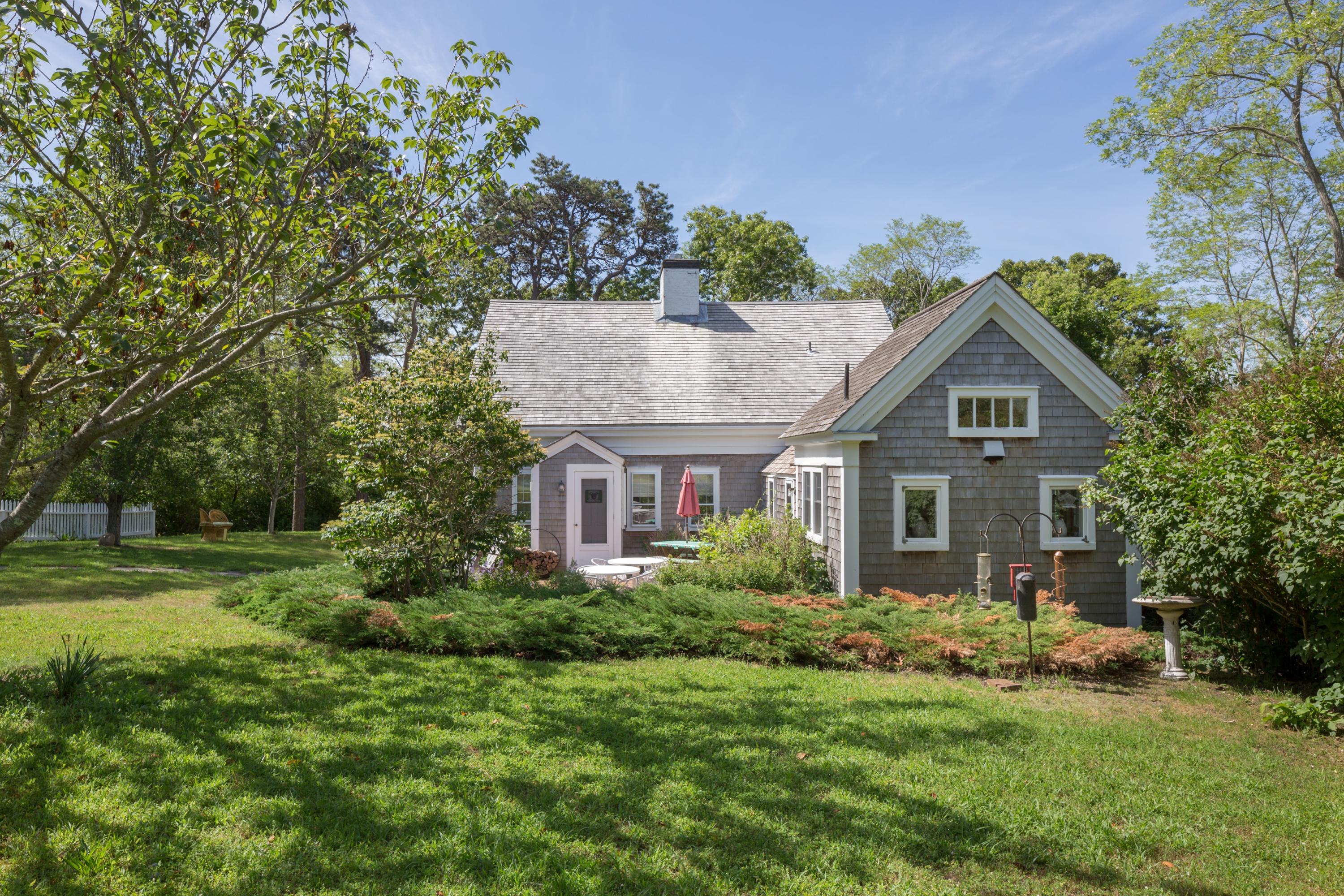 5 Depot Road Truro, MA 02666 - Photo 3 of 21 a front view of a house with a yard and trees