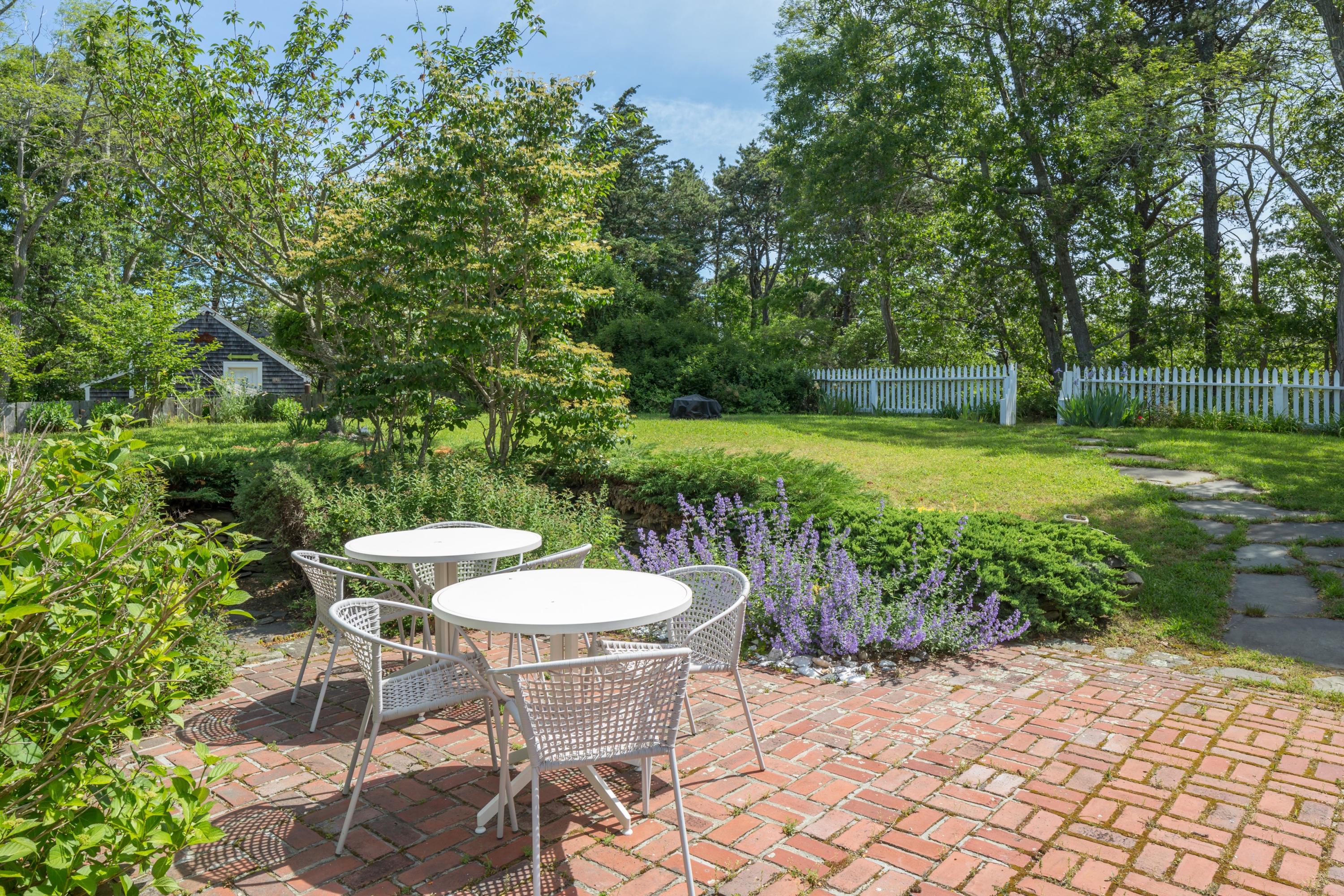 5 Depot Road Truro, MA 02666 - Photo 6 of 21 a view of a wooden table and chairs in patio
