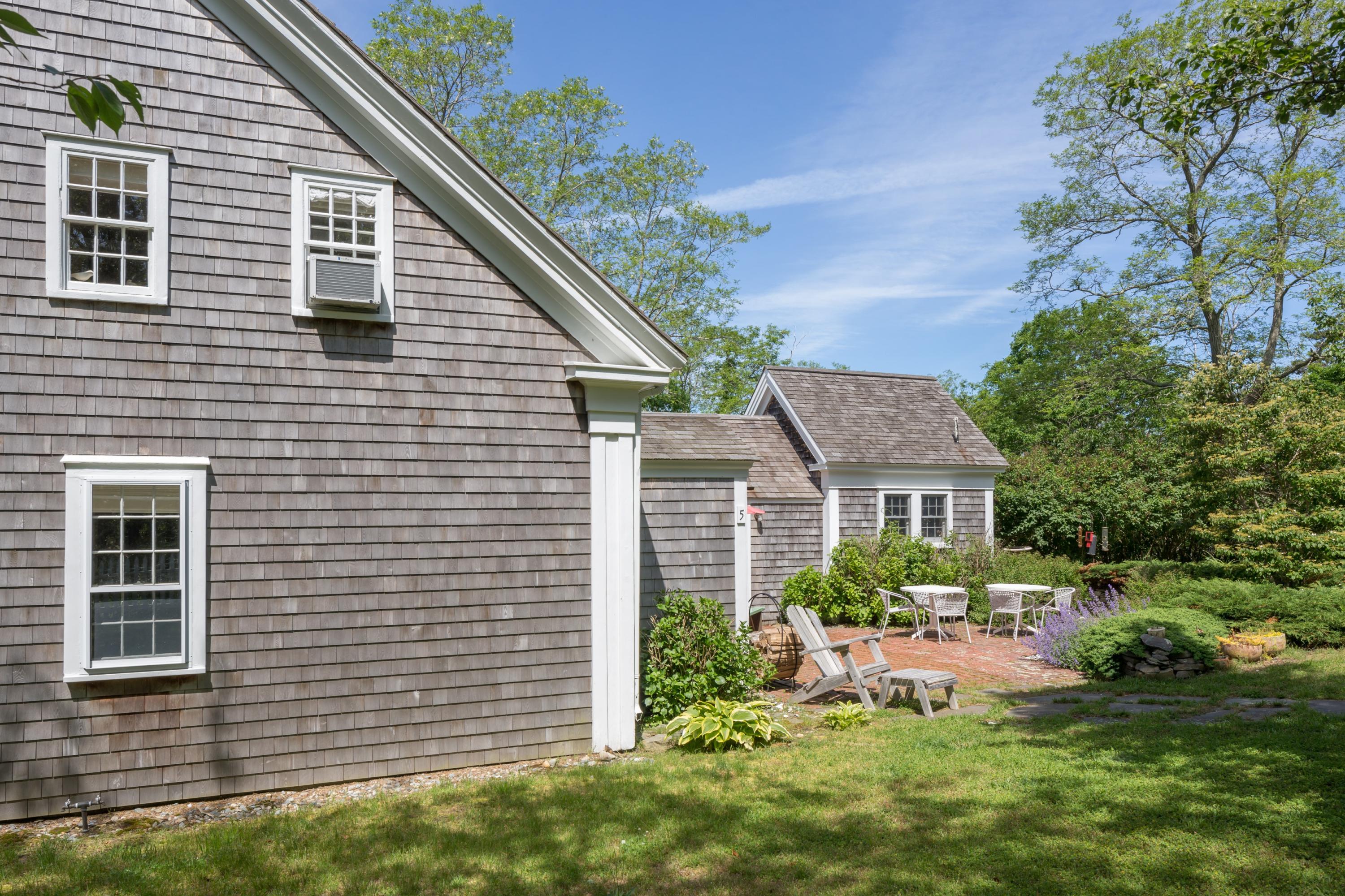 5 Depot Road Truro, MA 02666 - Photo 7 of 21 a front view of a house with a yard and a garage