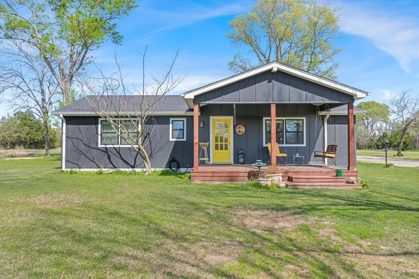 a view of a house with a yard porch and sitting area