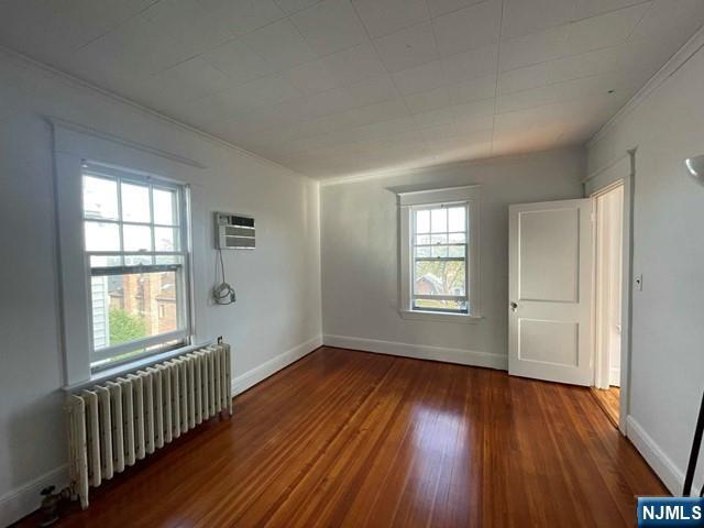 621 Undercliff Avenue, Unit 2 Edgewater, NJ 07020 - Photo 2 of 14 an empty room with wooden floor and windows