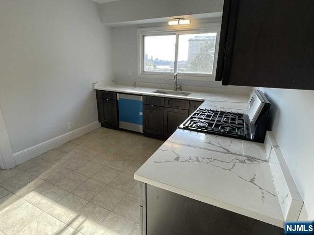 621 Undercliff Avenue, Unit 2 Edgewater, NJ 07020 - Photo 6 of 14 a kitchen with a sink a window and cabinets