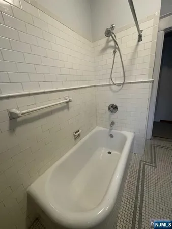 a bathroom with a white bath tub and a shower