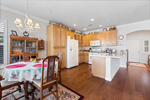 a view of kitchen with cabinets and wooden floor