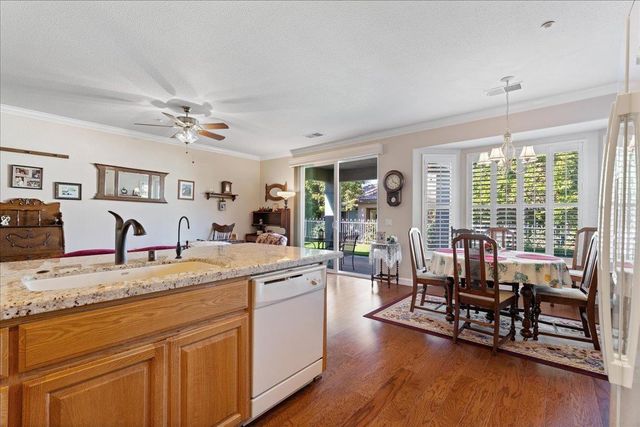 a view of living room with granite countertop furniture and wooden floor