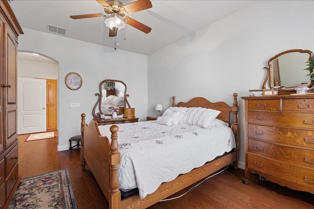 a bedroom with a bed and a dresser