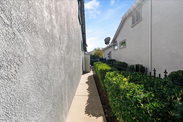 a view of a pathway of a building with a yard