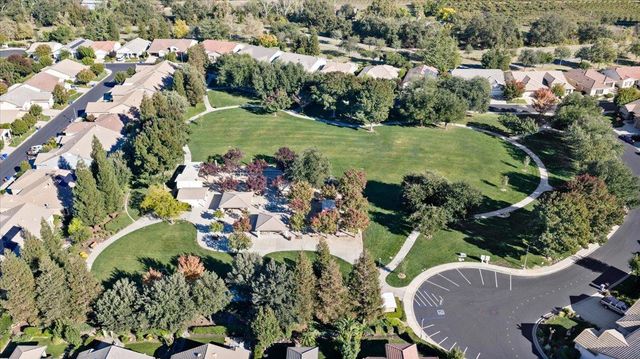 an aerial view of a house with a yard and lake