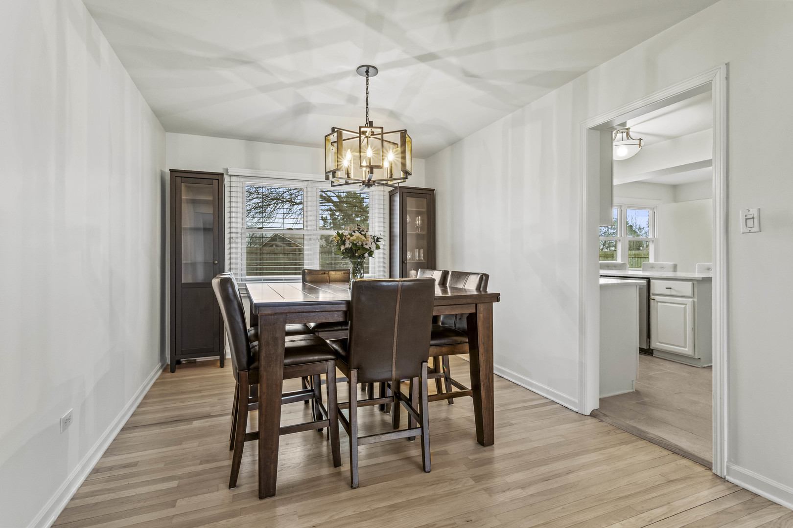 7209 Grant Street Darien, IL 60561 - Photo 12 of 37 a view of a dining room with furniture window and wooden floor