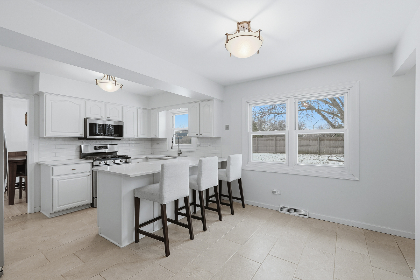 7209 Grant Street Darien, IL 60561 - Photo 13 of 37 a kitchen with stainless steel appliances granite countertop a stove and a refrigerator