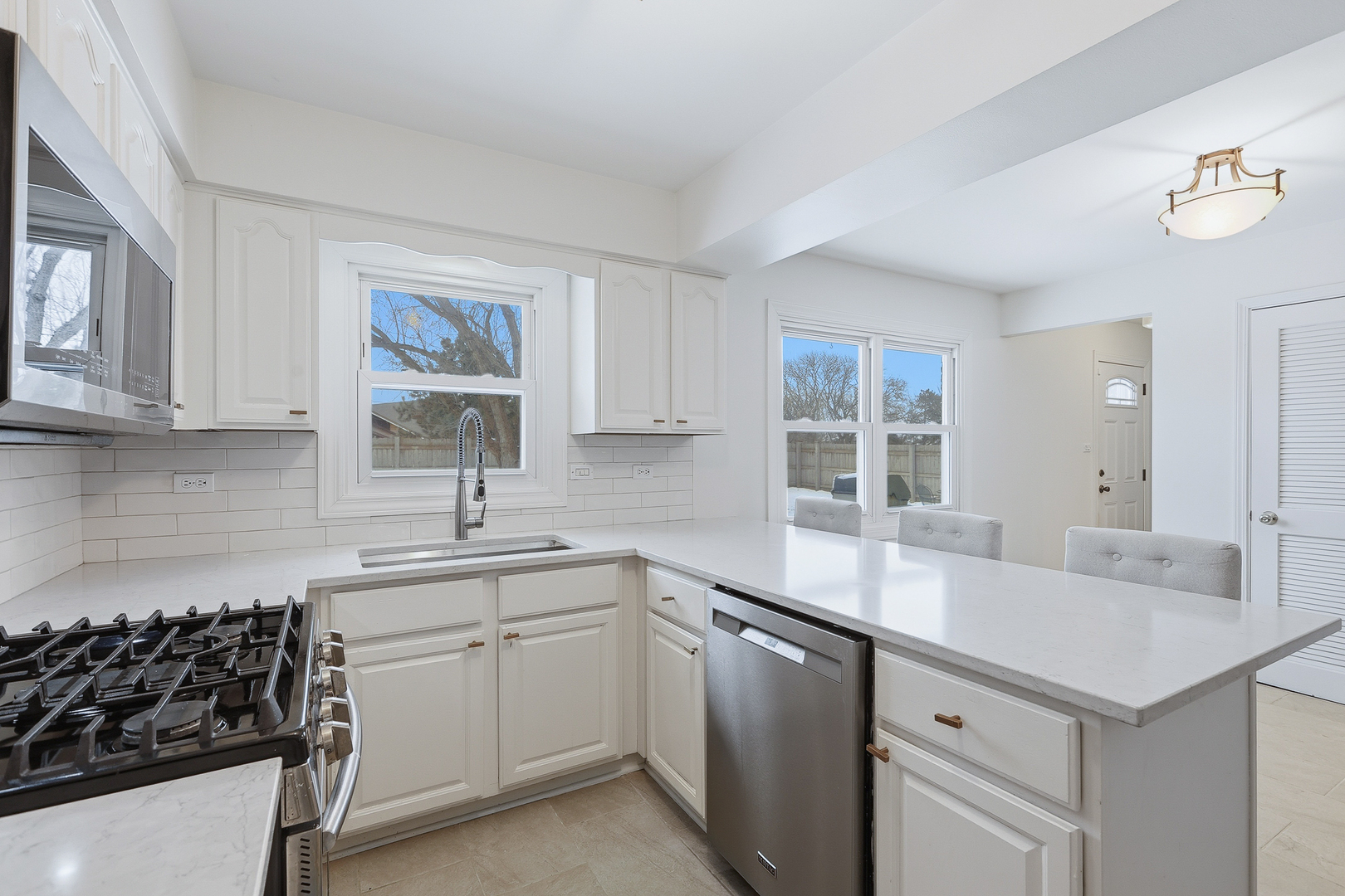7209 Grant Street Darien, IL 60561 - Photo 15 of 37 a kitchen with a sink stove and cabinets