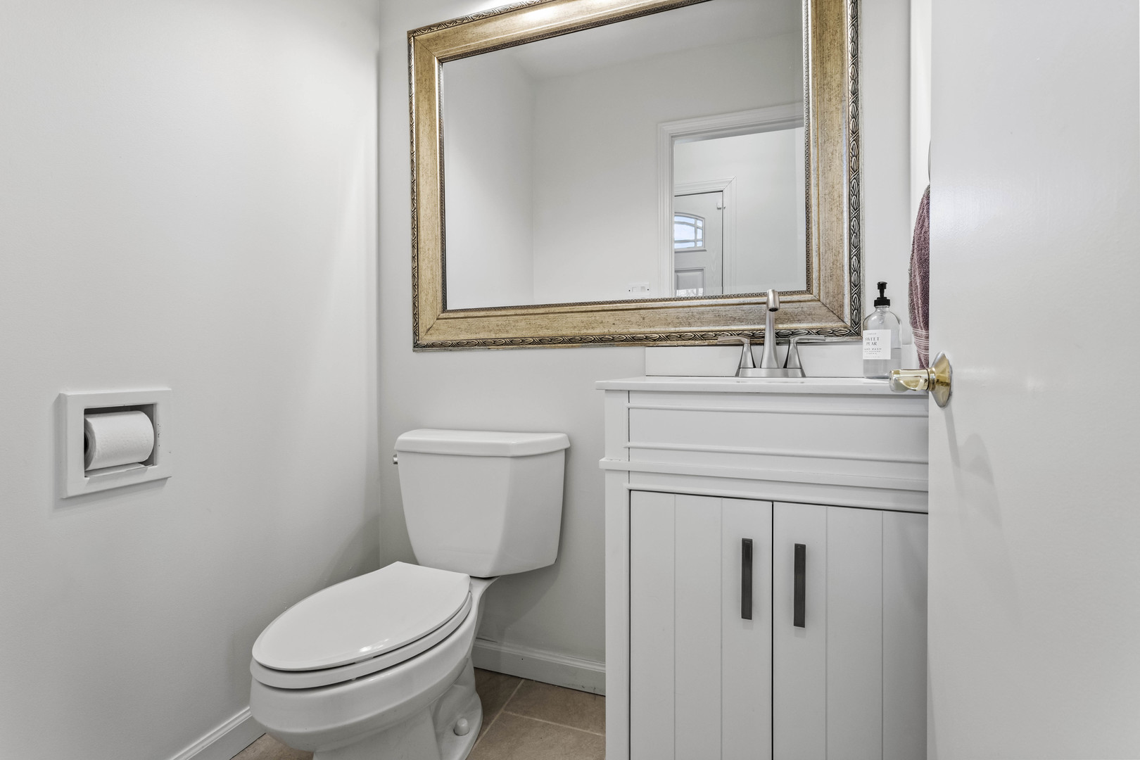 7209 Grant Street Darien, IL 60561 - Photo 20 of 37 a bathroom with a toilet sink vanity and mirror