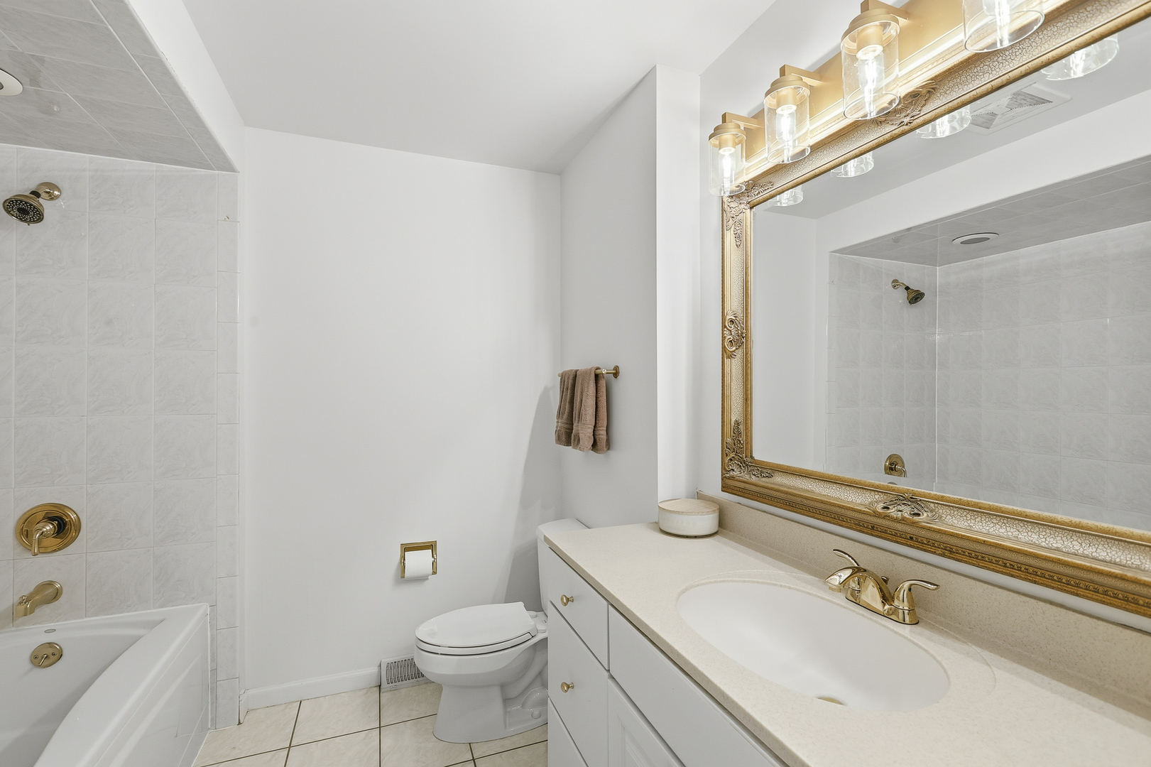 7209 Grant Street Darien, IL 60561 - Photo 28 of 37 a bathroom with a sink a toilet and shower