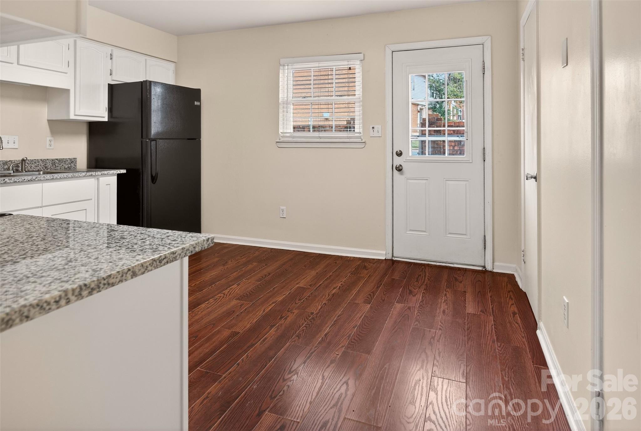 8816 Hunter Ridge Drive Charlotte, NC 28226 - Photo 11 of 14 a kitchen with granite countertop wooden floors and wide window