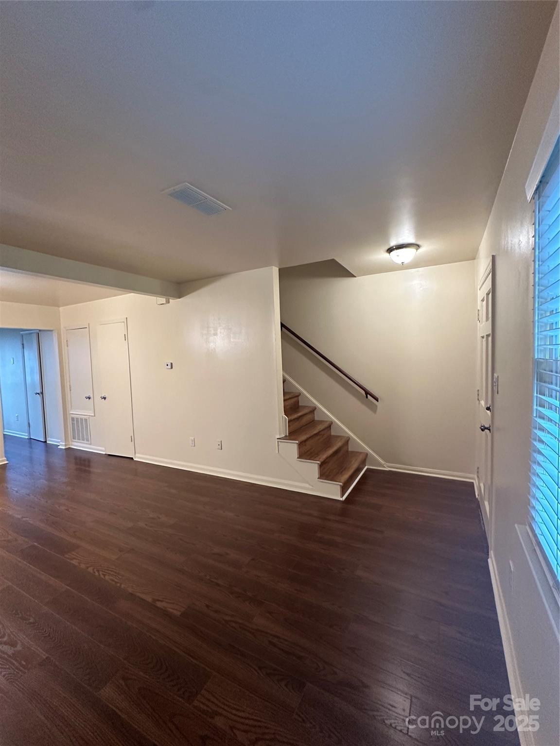 8816 Hunter Ridge Drive Charlotte, NC 28226 - Photo 6 of 14 a view of an empty room with wooden floor and stairs