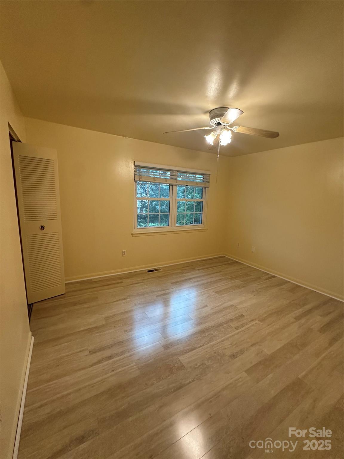 8816 Hunter Ridge Drive Charlotte, NC 28226 - Photo 7 of 14 an empty room with wooden floor and windows