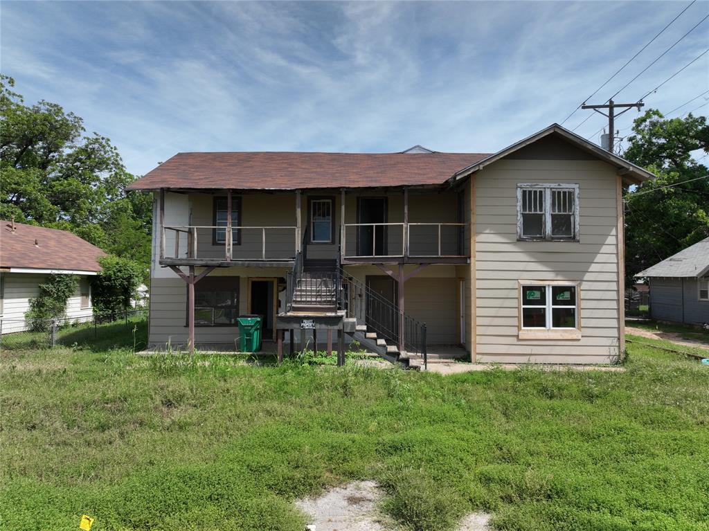 1428 Texas Street Vernon, TX 76384 - Photo 12 of 30 a front view of a house with a yard and garage
