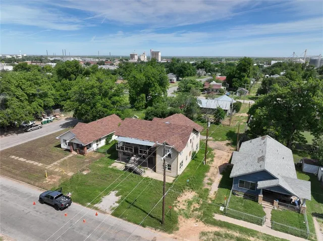 an aerial view of a house with garden space and street view