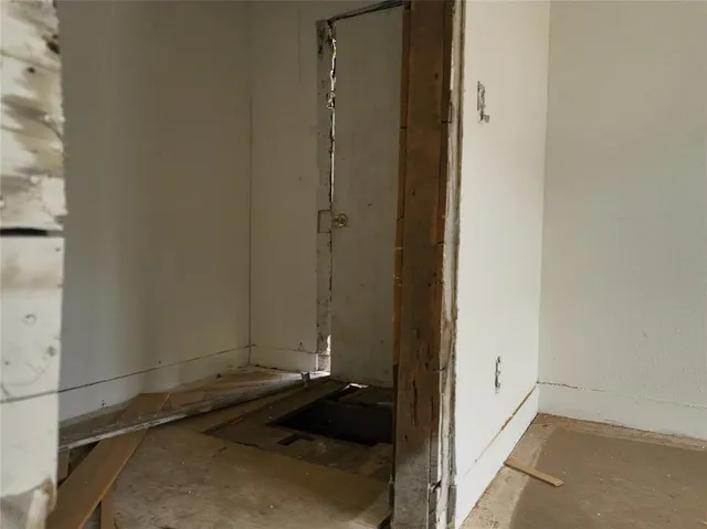 a view of a hallway with a wooden floor